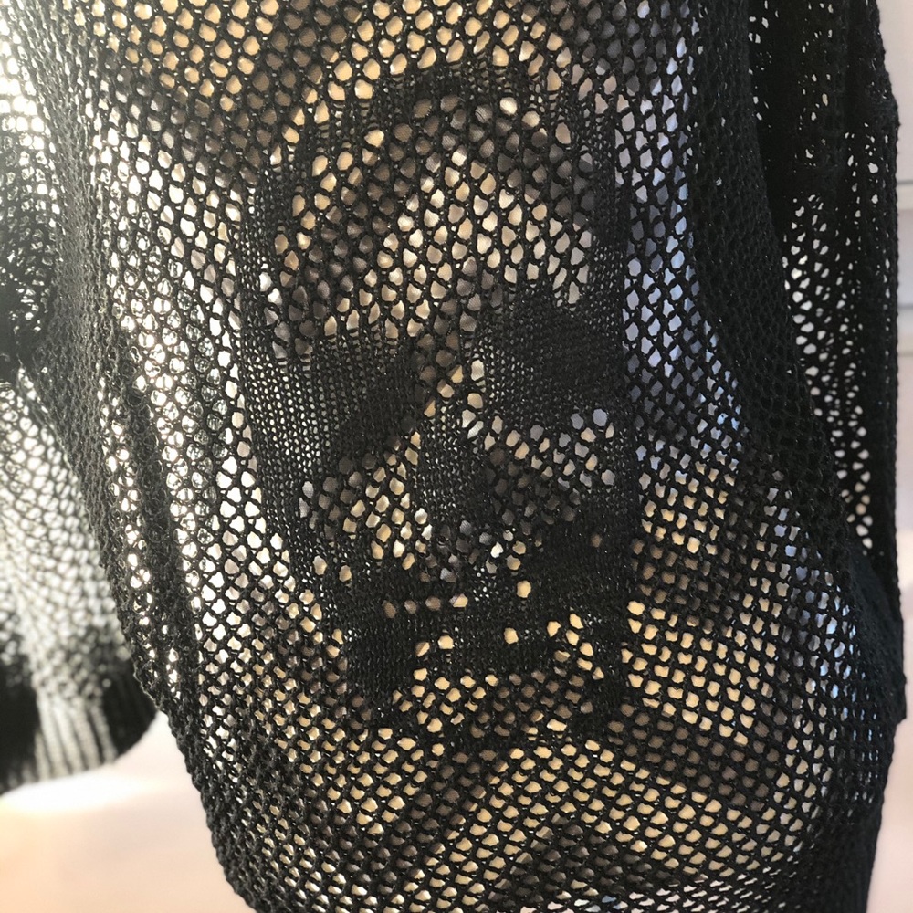 Open knit sweater with embroidered skull on back